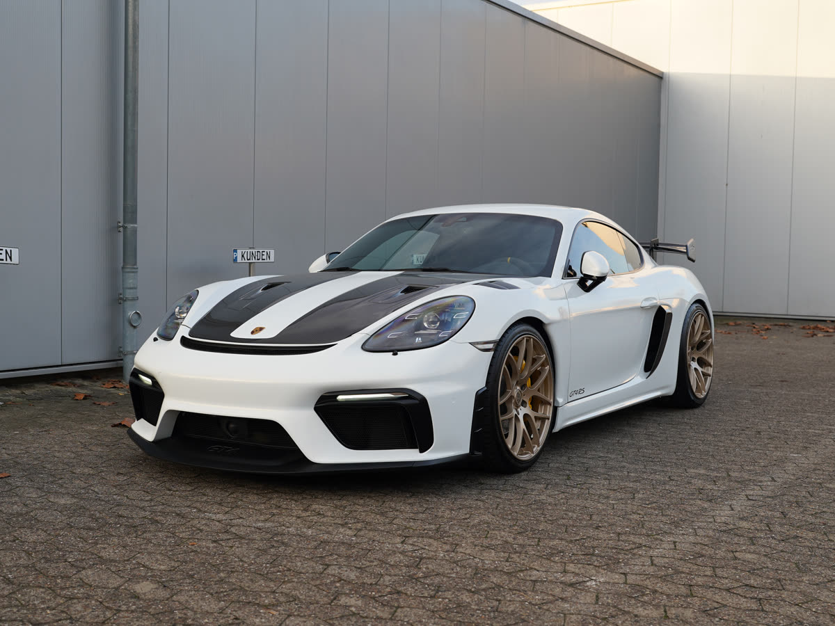 Weißer Porsche Cayman GT4 RS mit Carbonhaube von schräg vorn